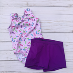 Load image into Gallery viewer, Pink with colorful sprinkles preschool girls gymnastics dance tank leotard with matching scrunchie and optional coordinating purple shorts
