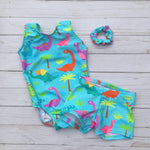 Load image into Gallery viewer, Cute dinosaur and palm tree print on turquoise background tank gymnastics dance leotard with matching shorts and scrunchie options
