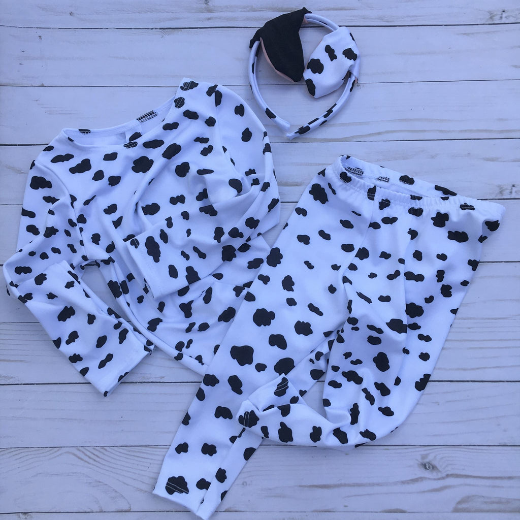 Kids Halloween Dalmatian print costume in long sleeves, matching pants with attached tail and ear headband.  White with black dog print spots