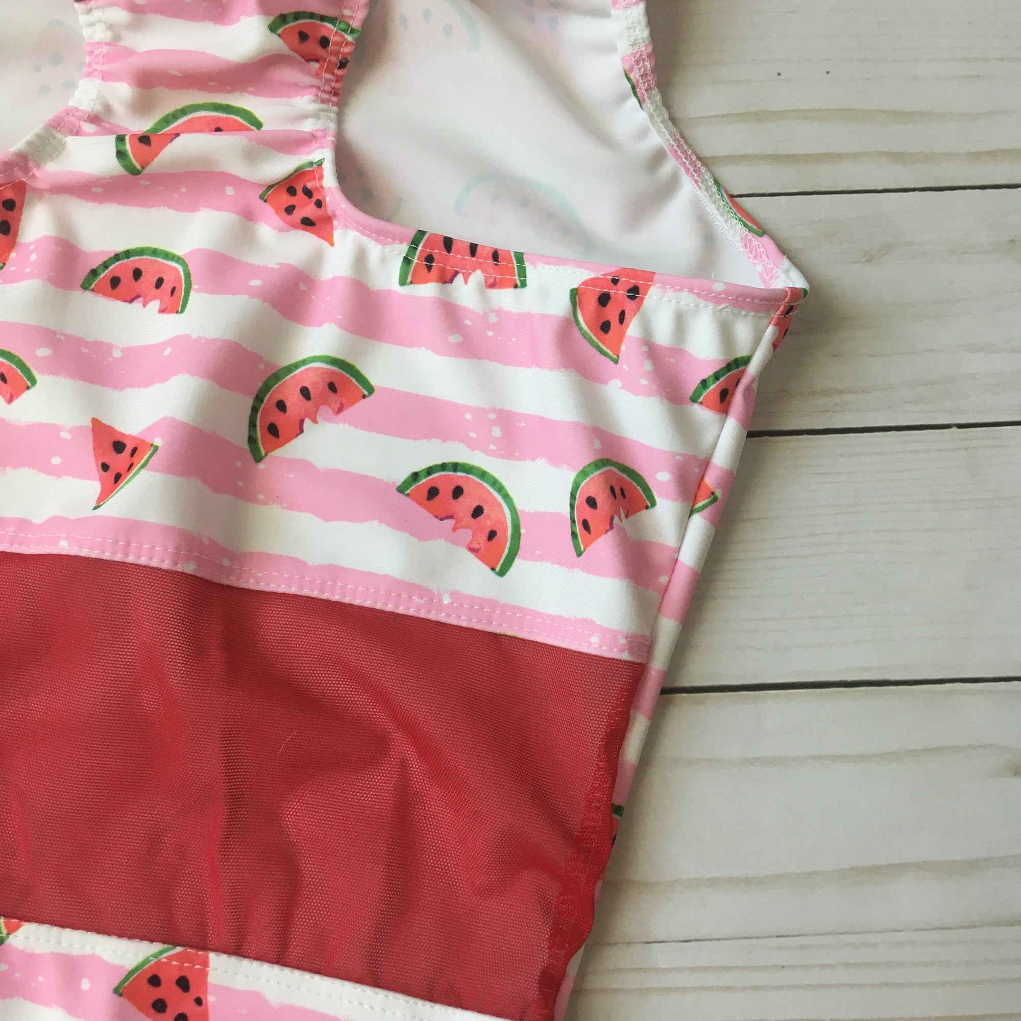 close up of racerback watermelon leotard with red mesh in mid back