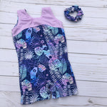 Load image into Gallery viewer, girls gymnastics biketard in soft pastel colored palm print with accented lavender top
