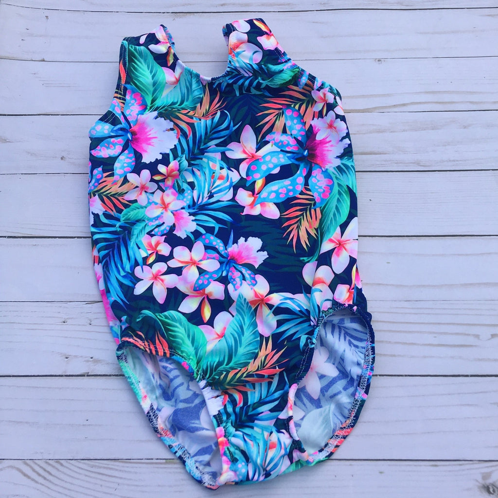 Vibrantly colored tropical flowers in pinks, blues and soft greens. Tank style girls gymnastics leotard
