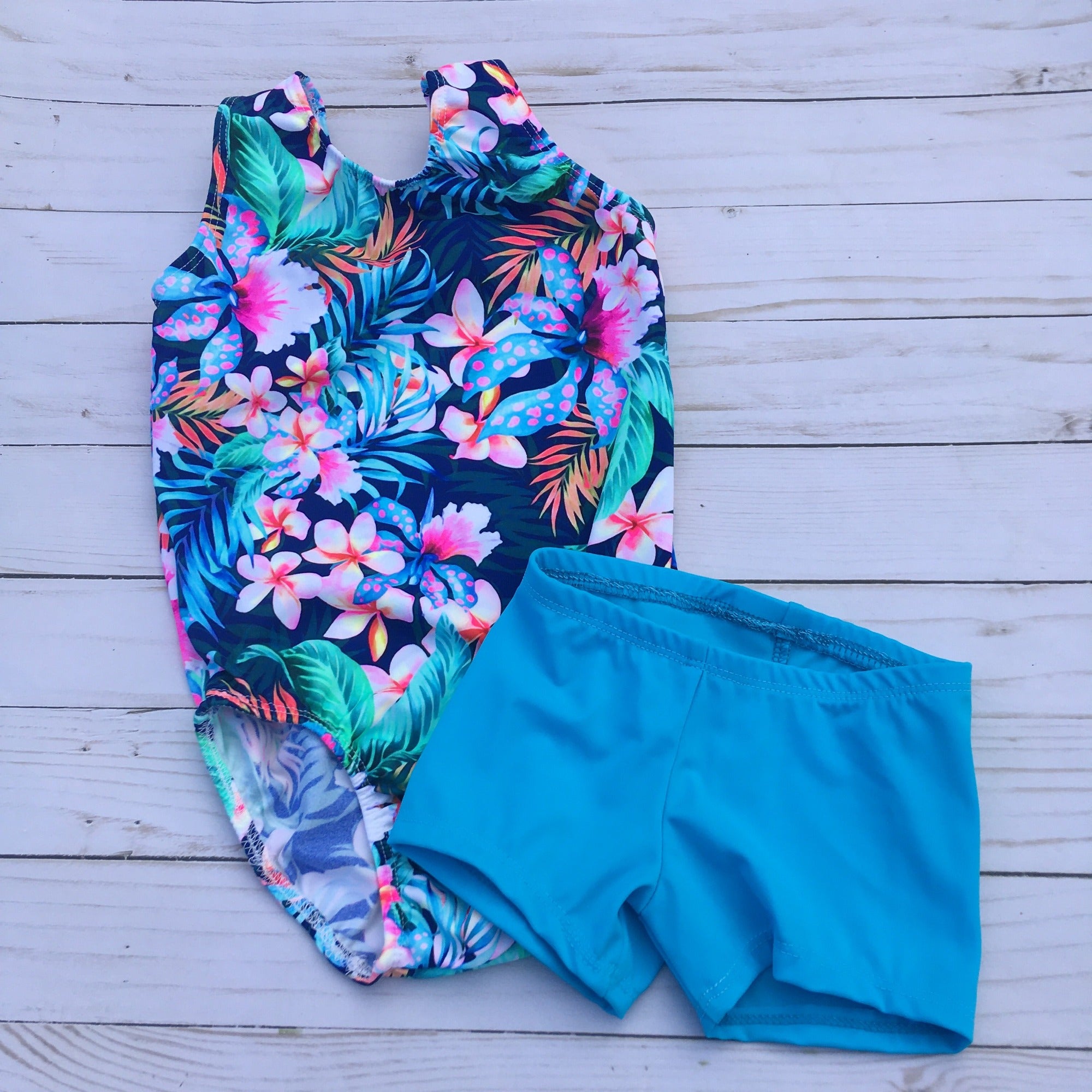 bright floral tank gymnastic leotard with coordinating turquoise shorts